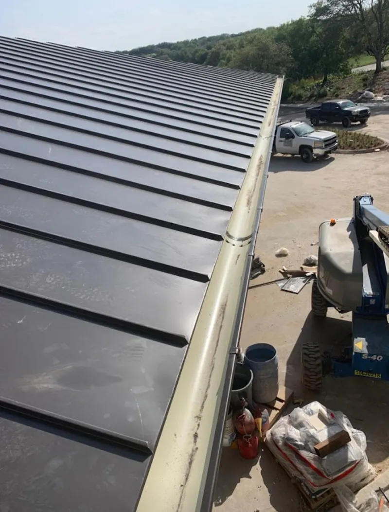 Standing seam panel and gutter detail on a metal roofing jobsite in Whitpain